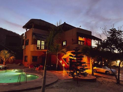 a house with a swimming pool in front of it at Private Home with Pool and Spa - Kayaks, Quad Rental in Las Palmas