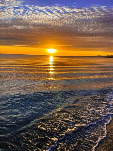 a sunset over the ocean with the sun setting at Private Home with Pool and Spa - Kayaks, Quad Rental in Las Palmas