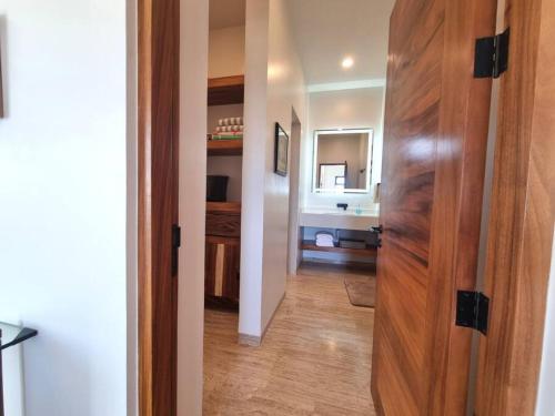a hallway with a door leading to a bathroom at Pool Condo, just a few steps from the beach -north in Los Barriles