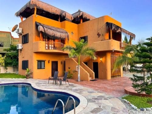 a house with a swimming pool in front of it at Private Home with Pool and Spa - Kayaks, Quad Rental in Las Palmas