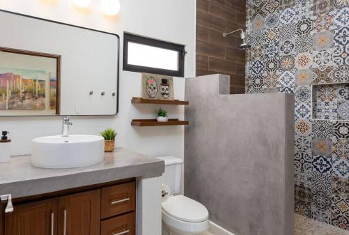 a bathroom with a sink and a toilet and a shower at Walkable, Convenient in Downtown Los Barriles in Los Barriles