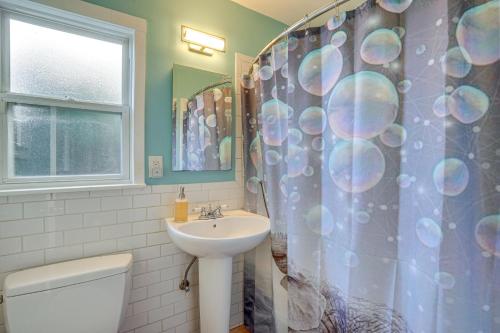 a bathroom with a sink and a shower curtain at Pet-Friendly Oakland Apt with Hot Tub and Fire Pit! in Oakland