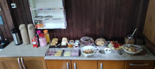 a kitchen counter with bowls of food on it at Pousada Floresta Das Estrelas in Urubici