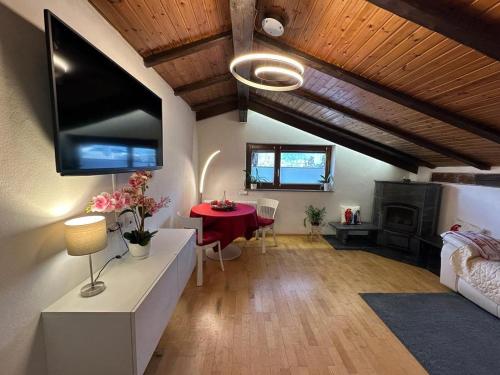 Plose Panorama House في بريسانون: غرفة معيشة مع طاولة ومدفأة