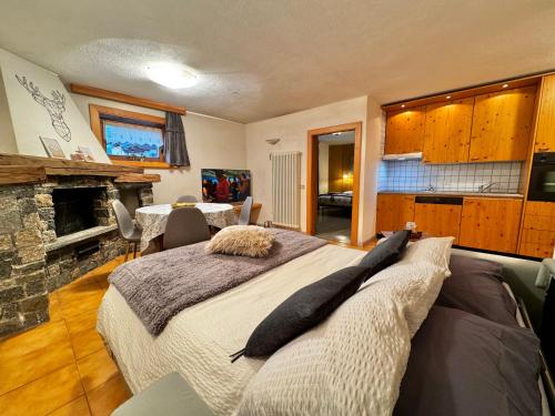 a bedroom with a large bed and a fireplace at Bait Ables in Livigno