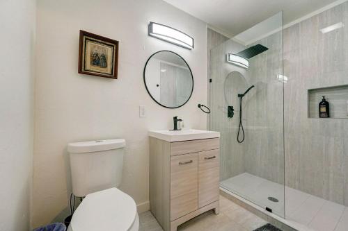a bathroom with a toilet and a shower with a mirror at Enchanting Home In Ideal Downtown Location in Oklahoma City