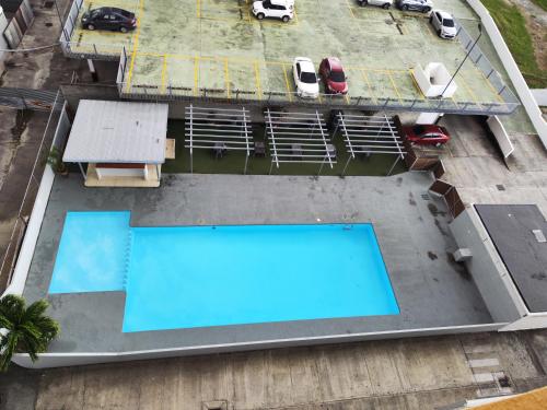 an overhead view of a swimming pool on a building at Cute apartment 5min from the airport in Salsipuedes