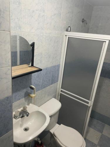 a bathroom with a toilet and a sink and a shower at Crisana - jerez in Floridablanca