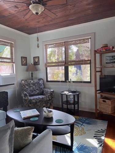 a living room with a couch and a table at The Cottage at Pineapple House in West Palm Beach