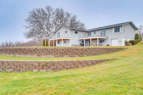 a large house on a hill with a stone wall at East Wenatchee Home about 2 Mi to Columbia River! in East Wenatchee