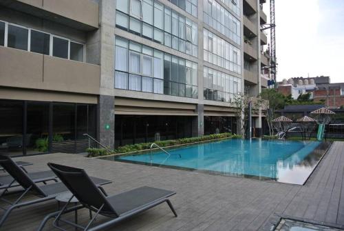 a large building with a swimming pool in front of a building at Cozy apartment in Mexico City. in Mexico City
