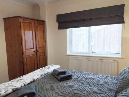 a bedroom with a bed and a window at Comfort Private Rooms in Three bedroom House in Bridgemary