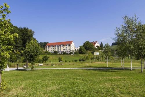 a large building in the middle of a field at Hotel Staribacher Südsteiermark in Leibnitz