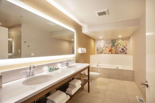 a bathroom with a sink and a toilet and a mirror at Riverside Hotel, BW Premier Collection in Boise