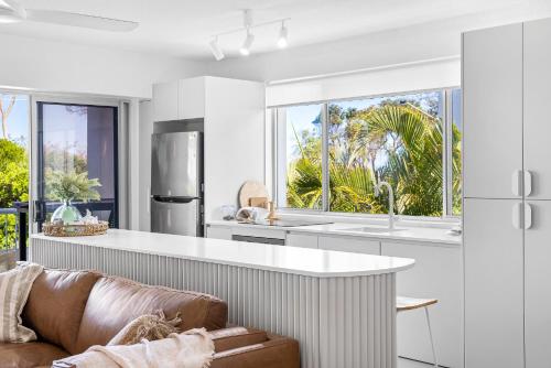 a kitchen with a couch and a large window at Maroochydore Beachfront in Maroochydore
