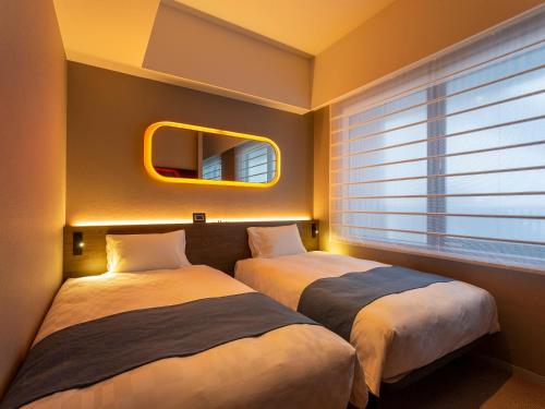 Llit o llits en una habitació de Royal Park Hotel Kurashiki