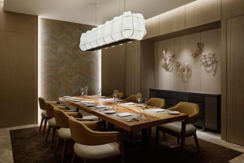 a dining room with a long table and chairs at TIAD, Autograph Collection in Nagoya