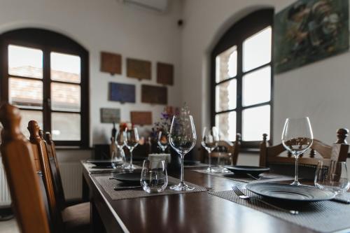 a table with wine glasses and plates on it at Crama Mircesti in Mirceşti