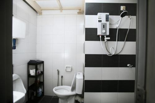 a bathroom with a black and white tiled wall at Private Zen at The CEO Bayan Lepas Penang in Bayan Lepas