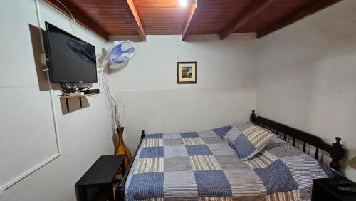 a bedroom with a bed and a flat screen tv at La Casa Maruja in Lima