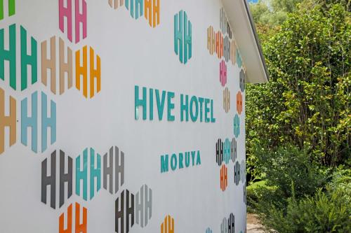 a wall with a sign that reads live hotel at Hive Hotel, Moruya in Moruya