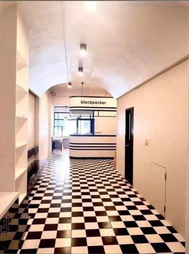 a hallway with a checkered floor in a building at Matcha House jomtien Pattaya in Jomtien Beach