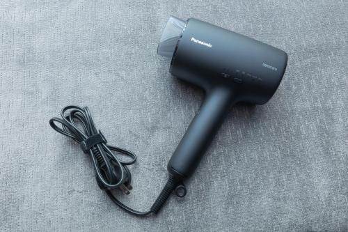 a black hair dryer with a cord on a table at Hotel Keihan Namba Grande in Osaka