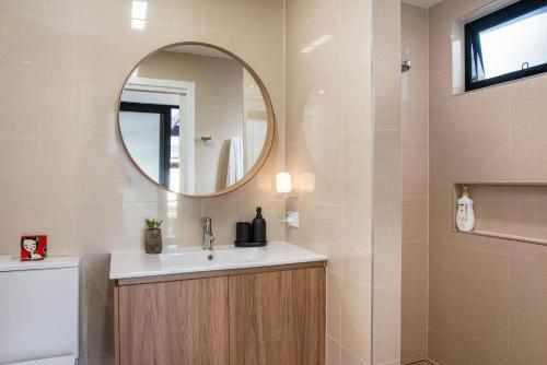 a bathroom with a sink and a mirror at Eco Bee Studio in Garden Serenity in Thebarton