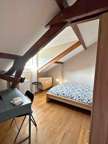 a bedroom with a bed and a desk in it at 7 chambres Paris Disneyland in Chelles