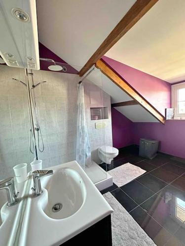 a bathroom with a sink and a purple ceiling at 7 chambres Paris Disneyland in Chelles