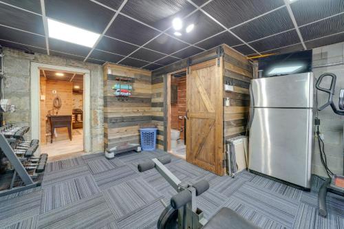 a gym with a refrigerator and some exercise equipment at Beckley Studio with Private Hot Tub and Home Gym! in Beckley