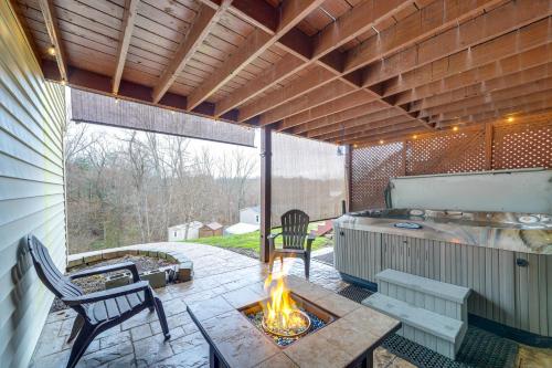 a screened in patio with a fire pit and chairs at Beckley Studio with Private Hot Tub and Home Gym! in Beckley