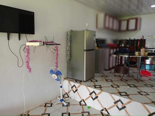 a kitchen with a refridgerator in a room at Tias appartment in Port Vila
