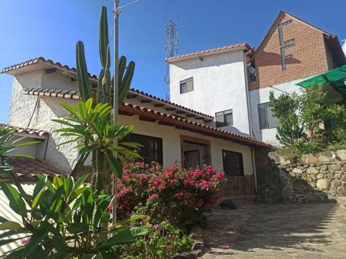 a house with plants and flowers in front of it at Fonda Amboró in Samaipata
