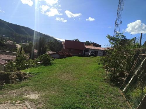 a yard with a view of a house at Fonda Amboró in Samaipata