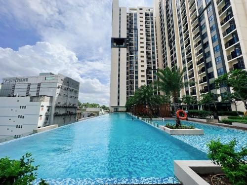 a large swimming pool in a city with tall buildings at Luxury houses in Ho Chi Minh City
