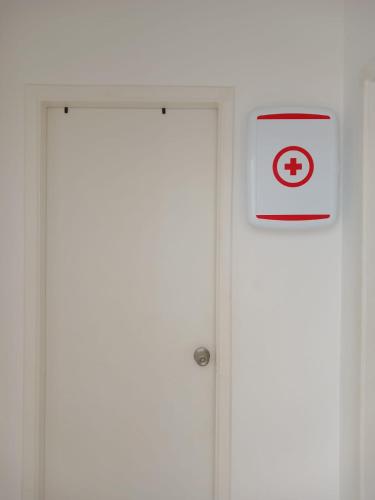 a white door with a sign on it next to it at Casa en Playa Privada - A pocos minutos de General Villamil Playas in Posorja