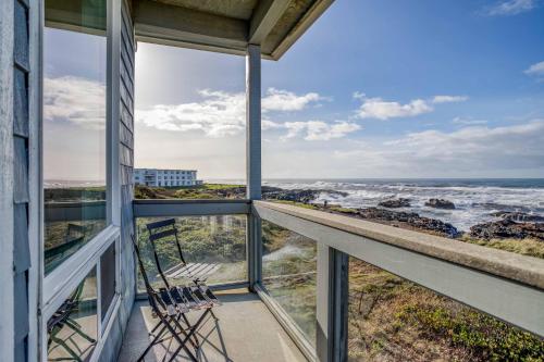 a balcony with chairs and a view of the ocean at Arbor House South in Yachats