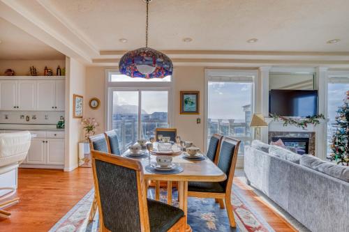 a dining room with a table and chairs and a couch at Arbor House South in Yachats