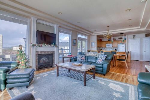 a living room with blue couches and a fireplace at Arbor House North in Yachats