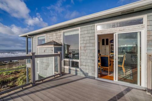 a house with sliding glass doors on a deck at Arbor House South in Yachats