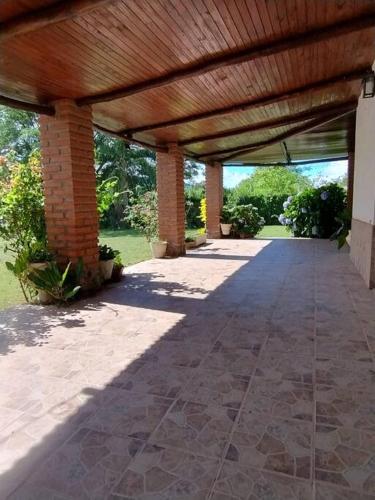 a covered walkway with a wooden roof on a building at Casona de Campo al Aire Libre in Lozano
