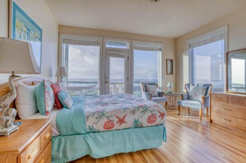 a bedroom with a bed with a view of the ocean at Arbor House in Yachats