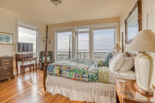 a bedroom with a bed and large windows at Arbor House in Yachats