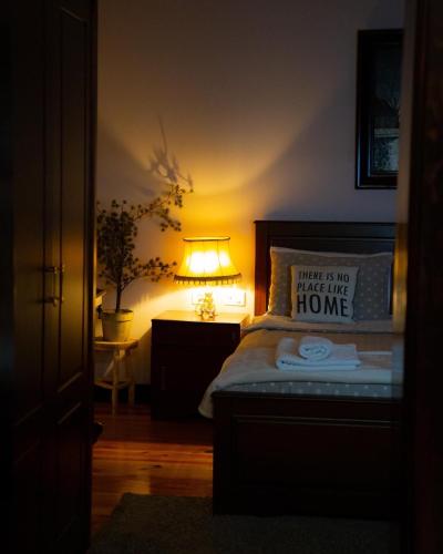 a bedroom with a bed with a pillow and a lamp at Villa Elezi 2 in Korçë