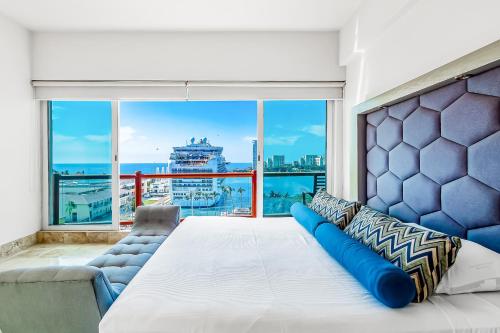a bedroom with a large bed and a large window at Deck 12 - 807 in Puerto Vallarta