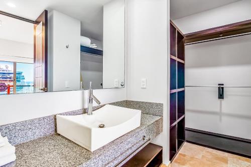 a bathroom with a sink and a mirror at Deck 12 - 807 in Puerto Vallarta