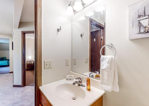 a bathroom with a sink and a mirror at Baraboo's Enchantment - Main in Baraboo