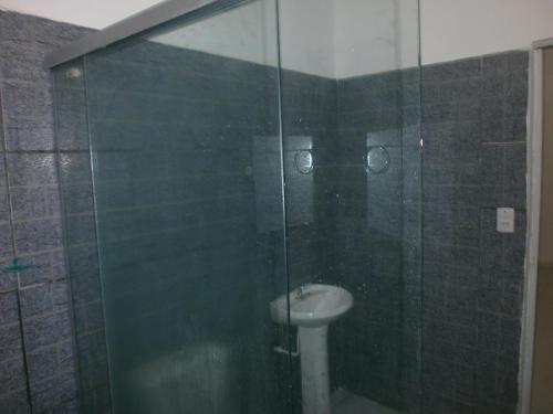 een badkamer met een glazen douche en een wastafel bij APARTAMENTO CAUAMÉ in Boa Vista