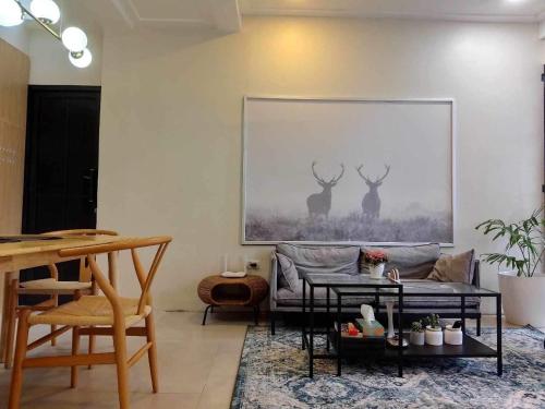 a living room with a couch and a picture of deer at Benita At the Plaza in Dolores